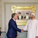 In this handout photo released by the Omani Ministry of Foreign Affairs on February 6, 2026, US special envoy Steve Witkoff shakes hands with Oman's Foreign Minister Badr bin Hamad al-Busaidi as Jared Kushner looks on during a meeting in Muscat.
